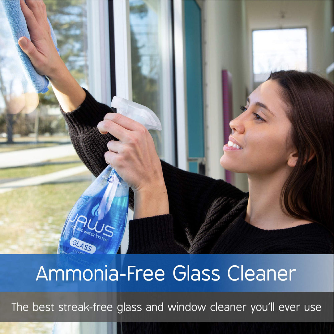 Woman cleaning window with JAWS Glass Cleaner and blue microfiber towel