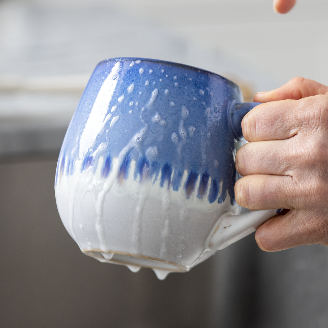 A blue mug with cleaning foam on it.