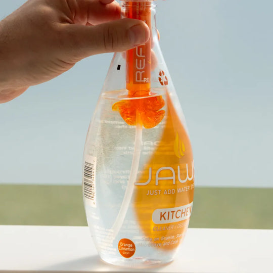 JAWS Kitchen Cleaner Bottle with refill pod releasing concentrate into bottle.