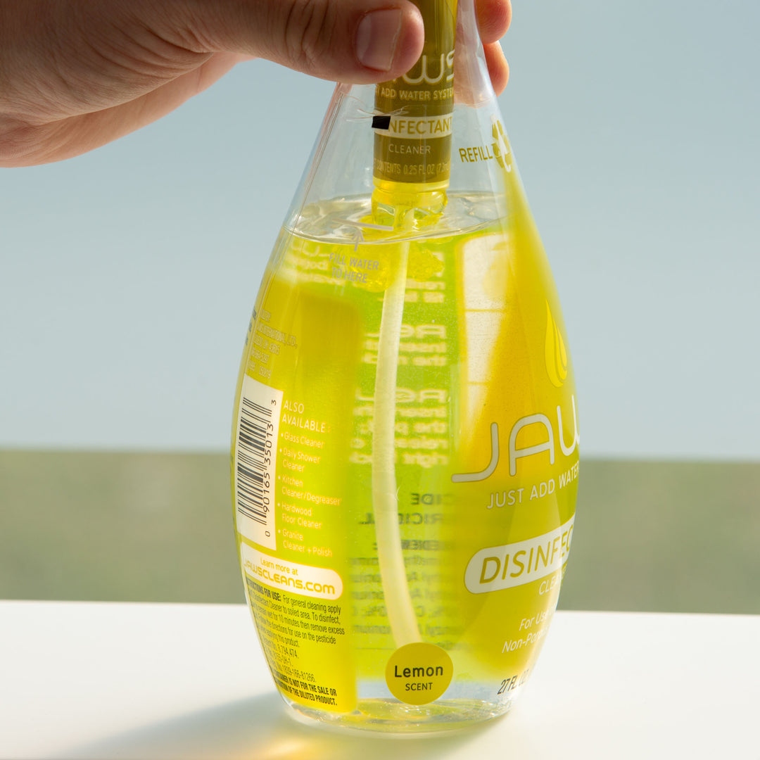 JAWS Disinfectant Cleaner Bottle with refill pod releasing concentrate into bottle.