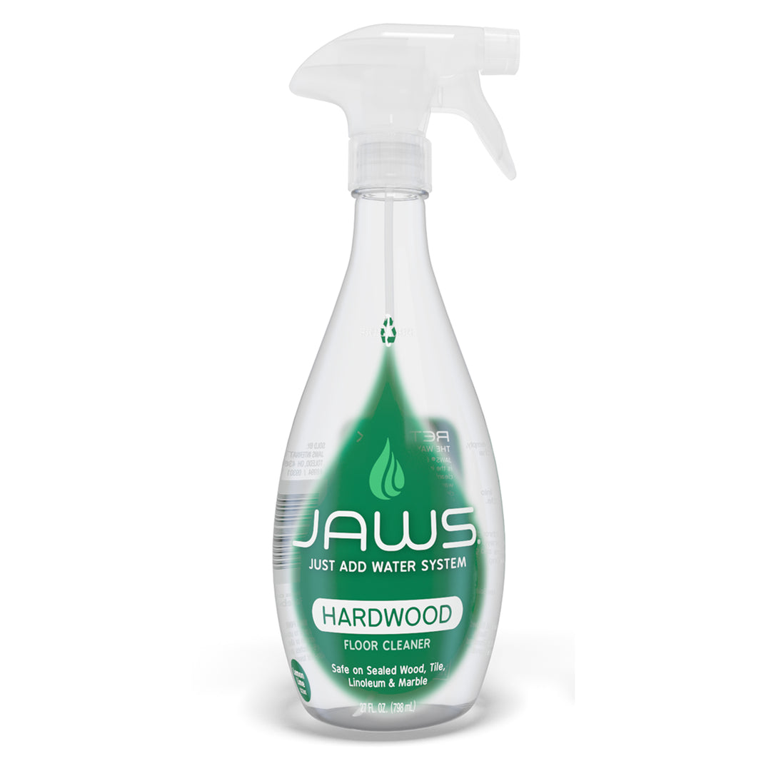 Clear, empty JAWS Hardwood Floor spray bottle with green label on a white background
