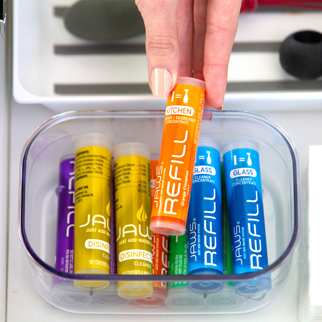 Hand taking out refill pod from container with JAWS refill pods.