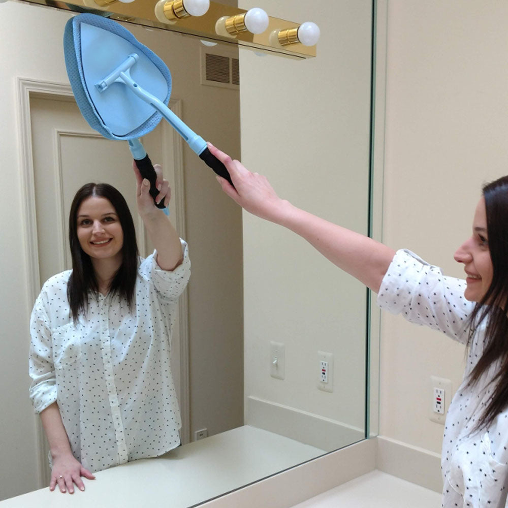 Woman cleaning bathroom mirror with JAWS cleaning wand