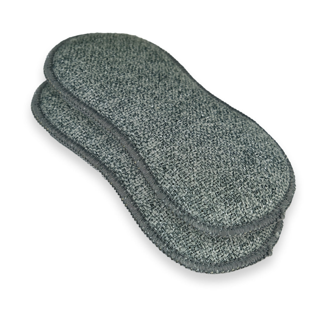 Two dark gray textured cleaning pads stacked on a white background.